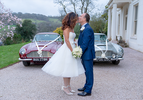 Vintage Aston Martin's at wedding.